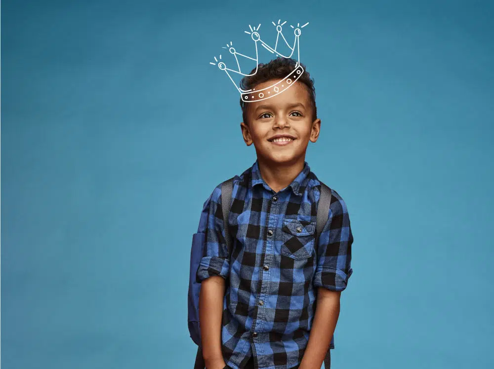 Primary School boy with backpack and crown